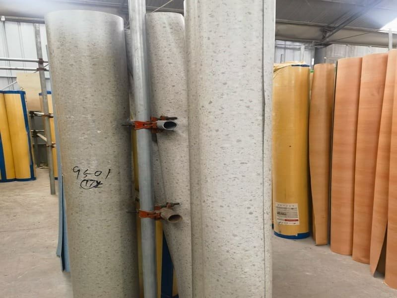 technician heat-welding a PVC sheet flooring seam in a corridor